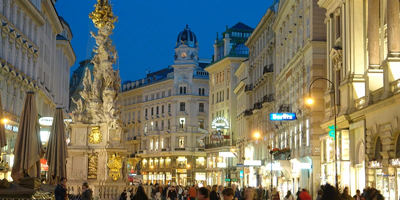 Graben at twilight with Pestsäule and illuminated shops