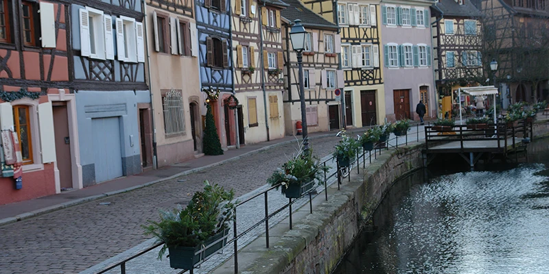 A quiet canal in Colmar bordered by timbered houses