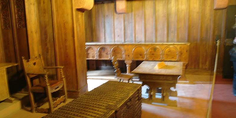 The great hall at Haut-Koenigsbourg with long wooden table and carved chairs
