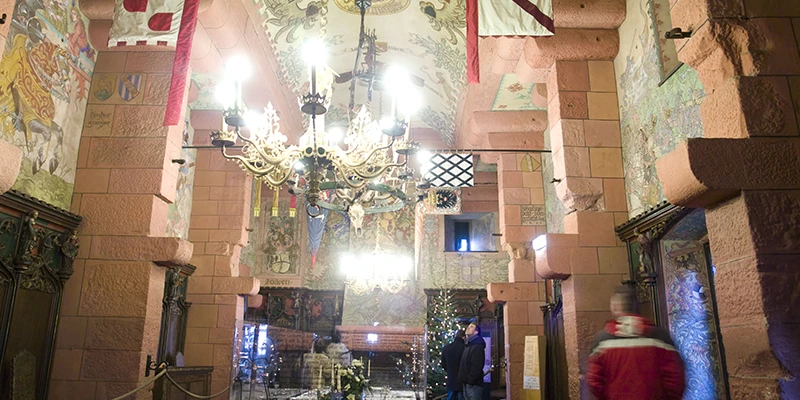 The banqueting hall at Haut-Koenigsbourg with chandelier and hanging banners