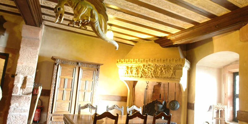 Room at Haut-Koenigsbourg with painted beams and heavy wooden furniture