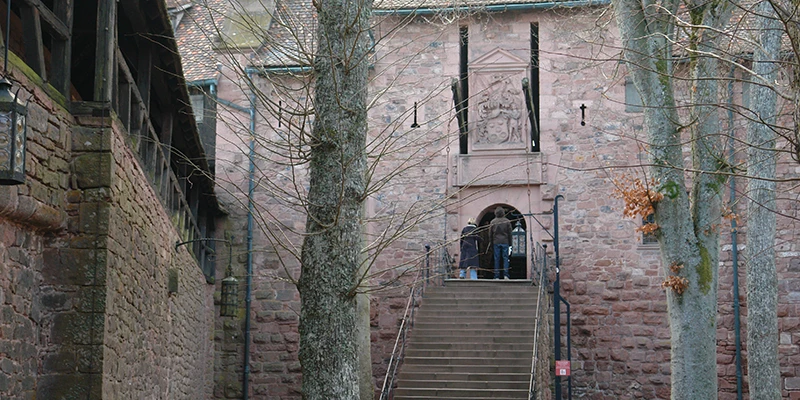 Steps rising to an inner gate at Haut-Koenigsbourg beneath hanging banners
