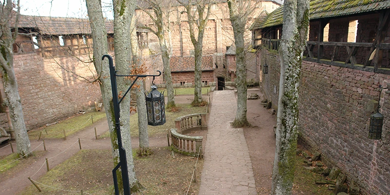 Walkway between the walls at Haut-Koenigsbourg with iron lamps