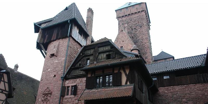 Half-timbered upper structure and tower at Haut-Koenigsbourg against the sky