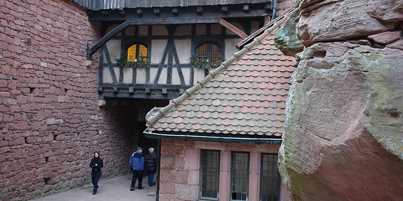 Half-timbered building and courtyard at Haut-Koenigsbourg with visitors