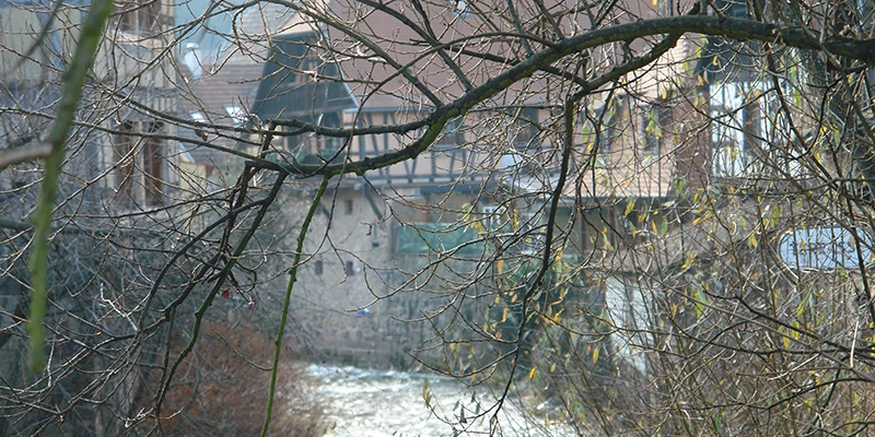 The Weiss stream running through Kaysersberg between bare winter trees