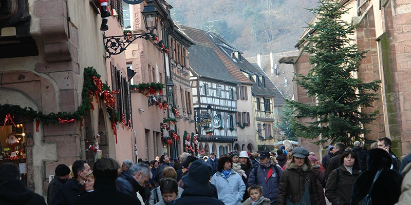 The Kaysersberg market street with the wooded ridge rising above the village