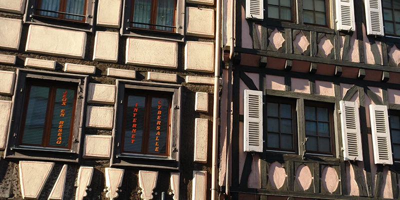 Half-timbered facade with shuttered windows on the main street of Kaysersberg