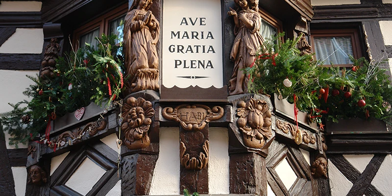 Carved oriel window in Ribeauvillé bearing the inscription Ave Maria Gratia Plena