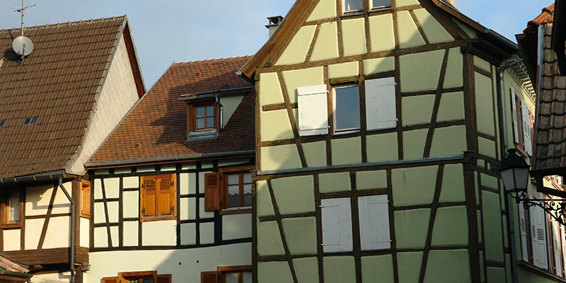 Green and white half-timbered house in Ribeauvillé