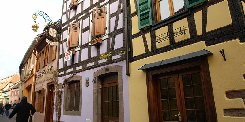 Pale painted houses along a quiet street in Ribeauvillé