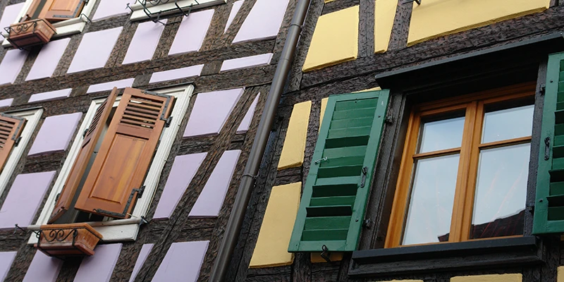 Detail of colorful timber framing and shuttered windows in Ribeauvillé