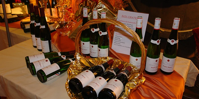 Display of Alsace wine bottles in a Riquewihr tasting room