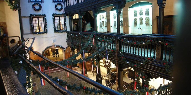 Lit shopfronts along a covered arcade in Strasbourg