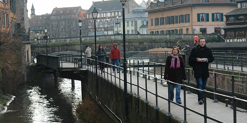 Pedestrians crossing a canal lock in Strasbourg