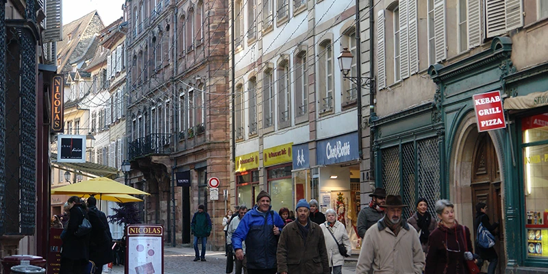 Shoppers filling a pedestrian shopping street in central Strasbourg