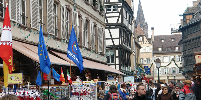 Rows of Christmas market booths along a Strasbourg street