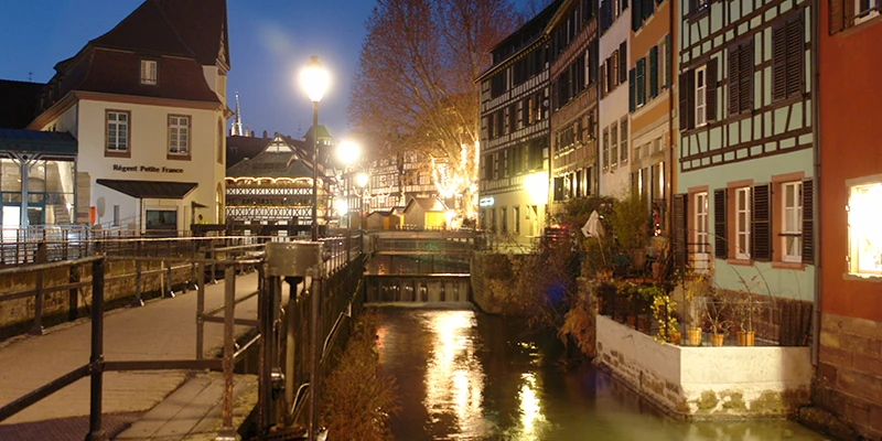 A Strasbourg canal lit at night during the Christmas season