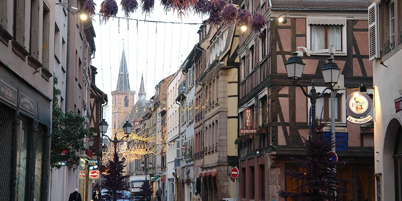 A Strasbourg street of half-timbered houses with the cathedral beyond