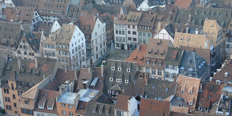 Steep tiled roofs and dormers of the Strasbourg old town seen from above
