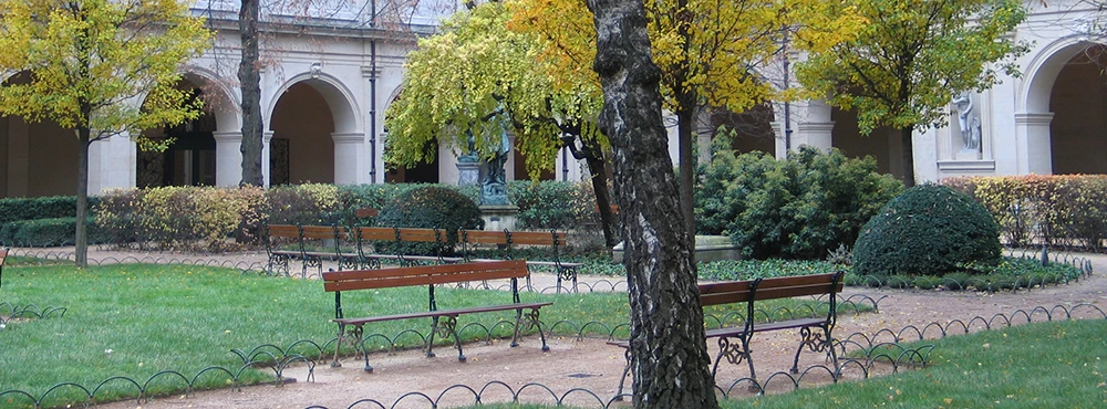 Park in Lyon with benches beneath autumn trees