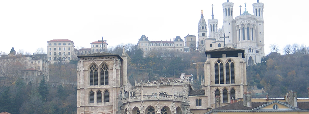 Roman theater ruins on Fourviere hill in Lyon with the basilica above
