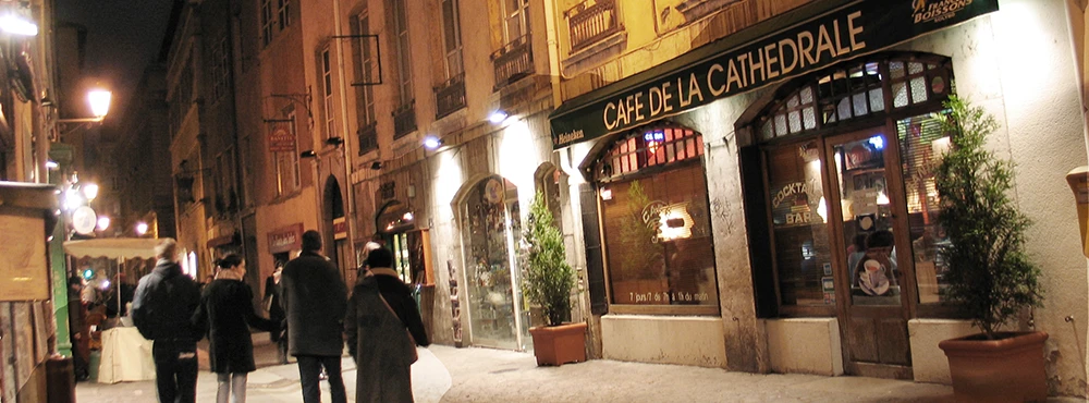 Street in Old Lyon at night with restaurant lights along the facades