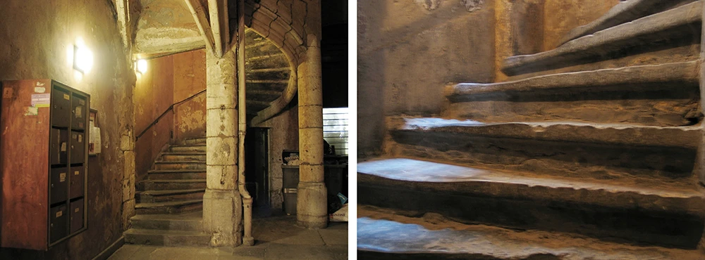 Lit interior passage of a Lyon traboule with a stone stairway