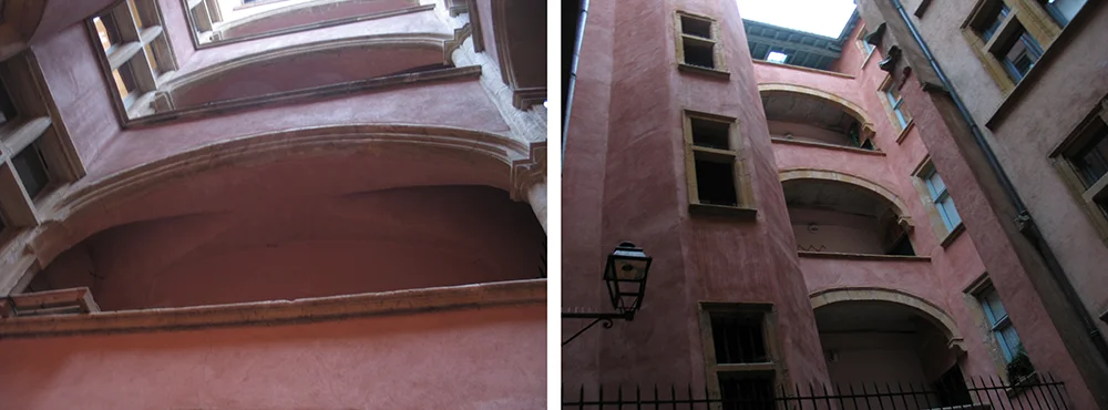 Pink courtyard with tiered stone arches inside a Lyon traboule
