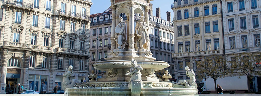 Fountain and ornate building facades on a square in Lyon