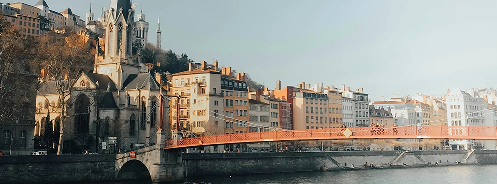 Red footbridge over the river in Lyon at dusk