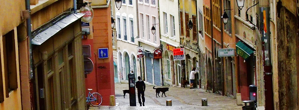 Street of colorful old buildings in Lyon with a pedestrian