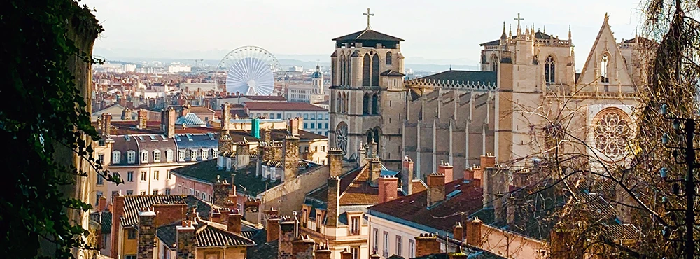 Aerial view over Lyon at dusk with the cathedral below the hill