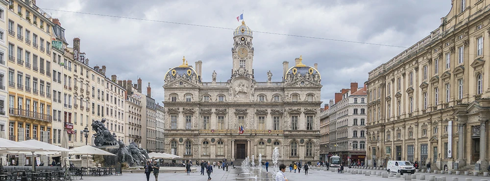 Grand civic building with a clock tower on a square in central Lyon