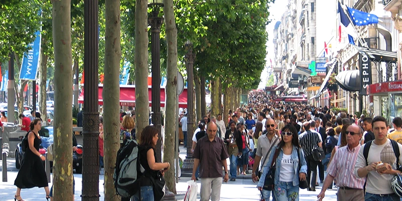 Crowds on the wide sidewalks of the Champs-Élysées, Paris