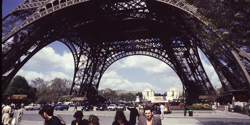 Looking up through the iron legs of the Eiffel Tower, Paris