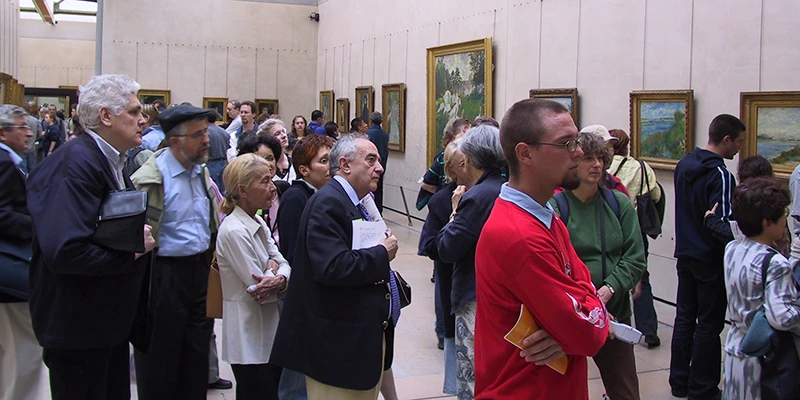 Visitors in a painting gallery at the Musée d'Orsay, Paris