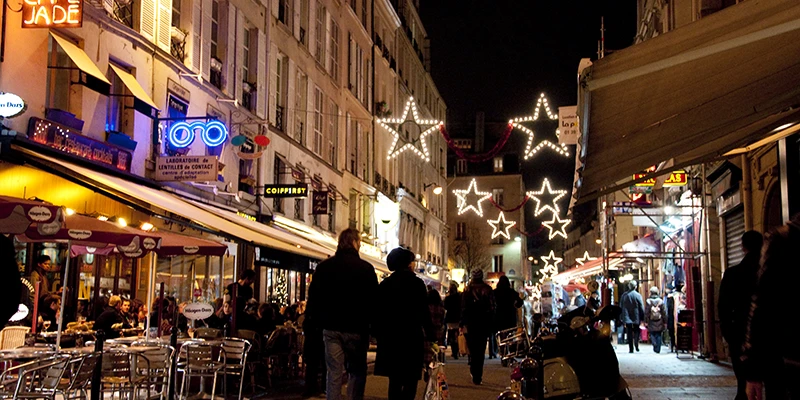 The Rue de Buci lit up in the evening, Paris