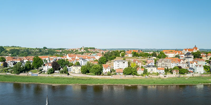 Panorama over Meissen from across the Elbe, with the green riverbank in the foreground