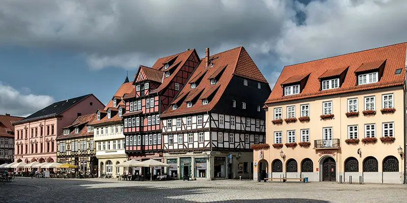 A row of varied half-timbered and stone houses lining the market square