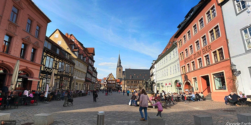 A row of varied half-timbered and stone houses lining the market square