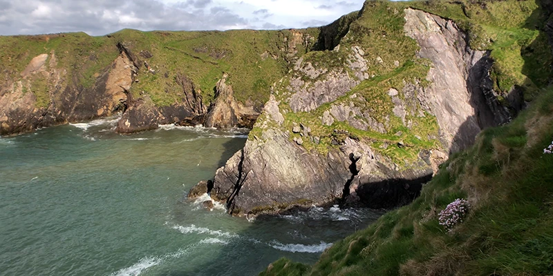 Dún Chaoin Harbor and pier with Blasket Islands offshore