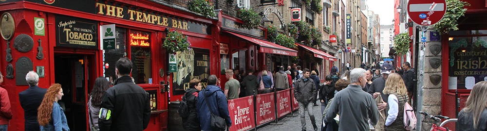 Crowds out on the cobbled streets of Temple Bar with colourful pub fronts