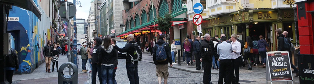 Temple Bar Square with open-air restaurant tables surrounded by pubs