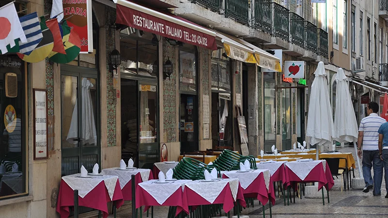 Restaurant terrace with red and white tablecloths in Lisbon