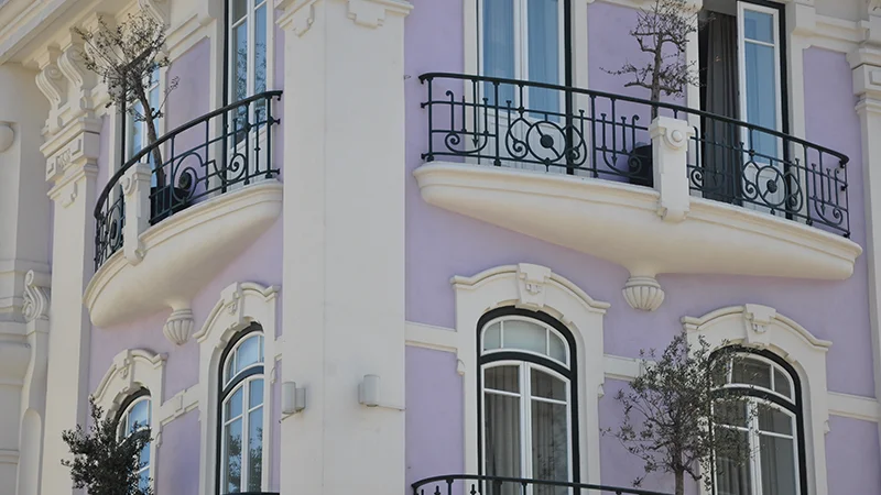 Pastel painted Baixa facade with iron balconies