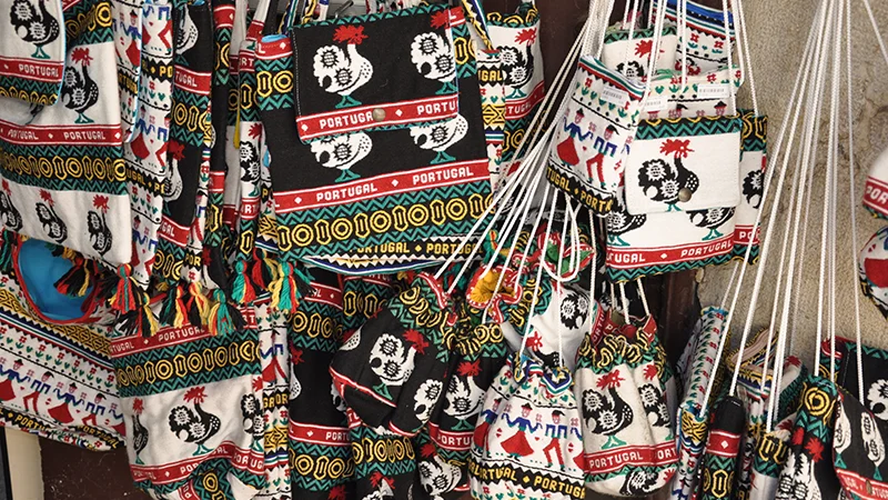 Display of colorful printed textiles and scarves in a Lisbon shop