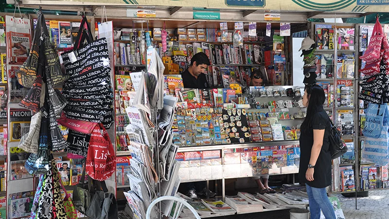 Kiosk stacked with postcards magnets and souvenirs in Lisbon