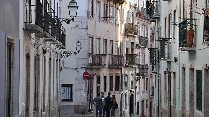 Bairro Alto street with an ornate lamp and old buildings