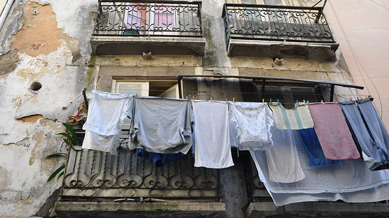 Laundry hanging from a balcony in Bairro Alto